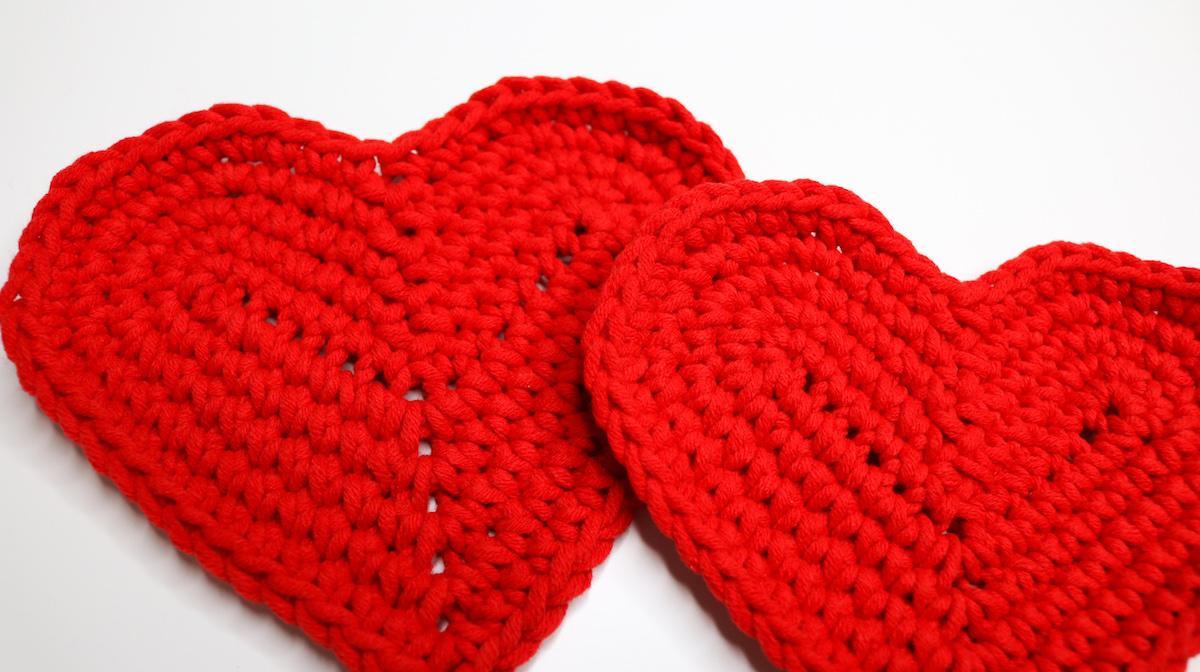 Two heart shaped coasters in red cotton yarn