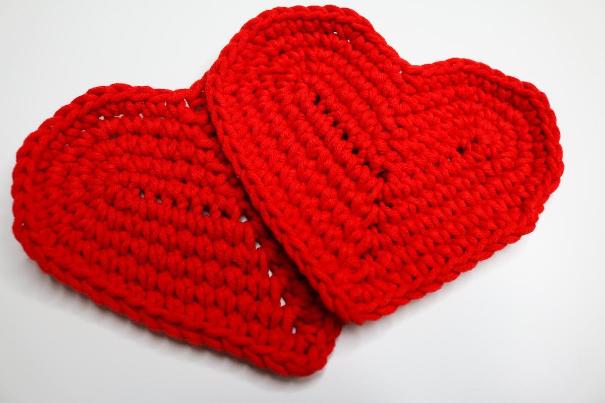 Two heart shaped coasters in red cotton yarn
