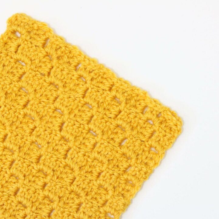 A yellow swatch of Corner to Corner crochet on a white background.