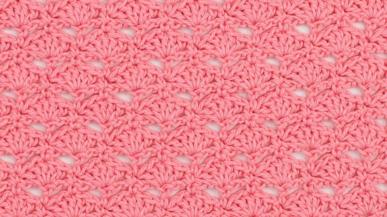 close up of a crochet swatch showing the little fans stitch in pink yarn