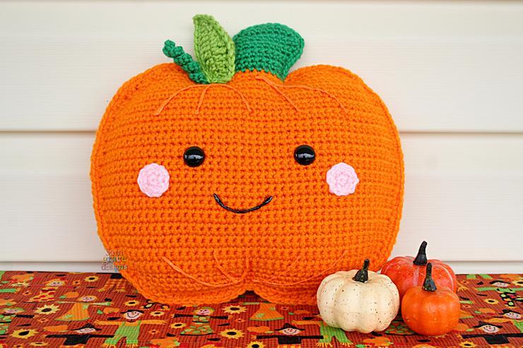 A cute Halloween pumpkin with a smiley face is displayed beside a trio of real gourds.