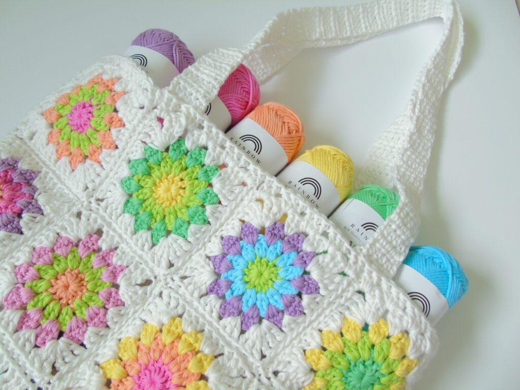 Crochet tote bag with starburst granny square design.