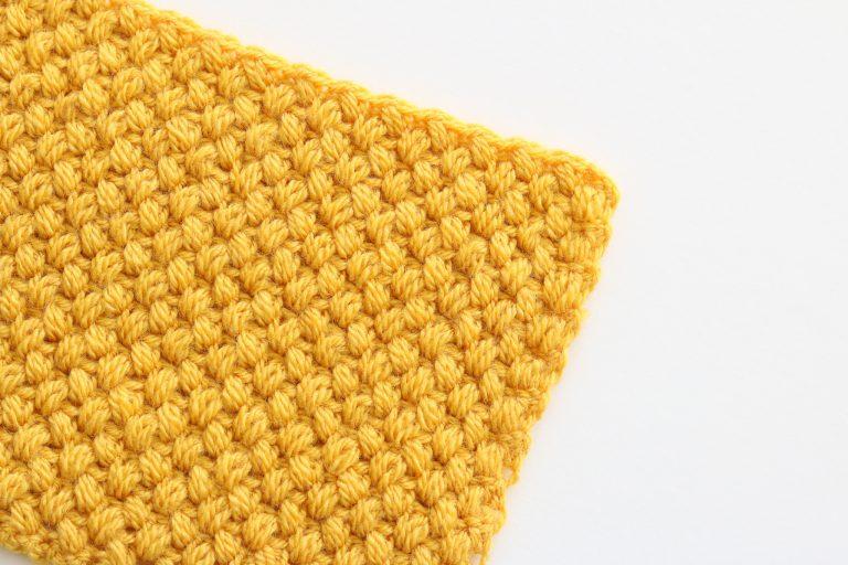 Close-up of crochet zig zag puff stitch in bright yellow yarn, showing textured and raised puff stitch pattern for crochet tutorials and projects