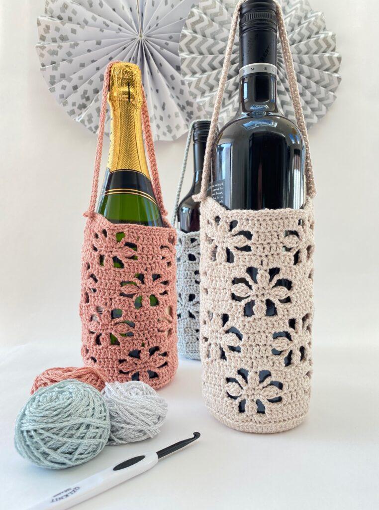 Selection of three Crochet Bottle Wraps in coral, cream and blue