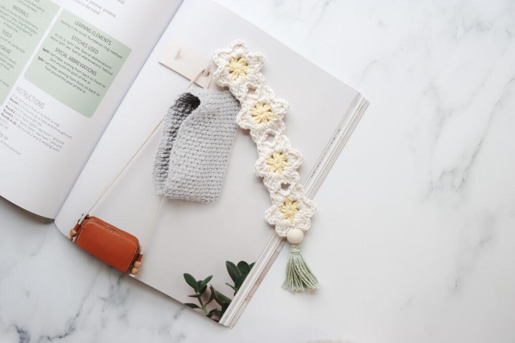 Crochet Daisy Bookmark laid on top of the Bella Coco Crochet Book