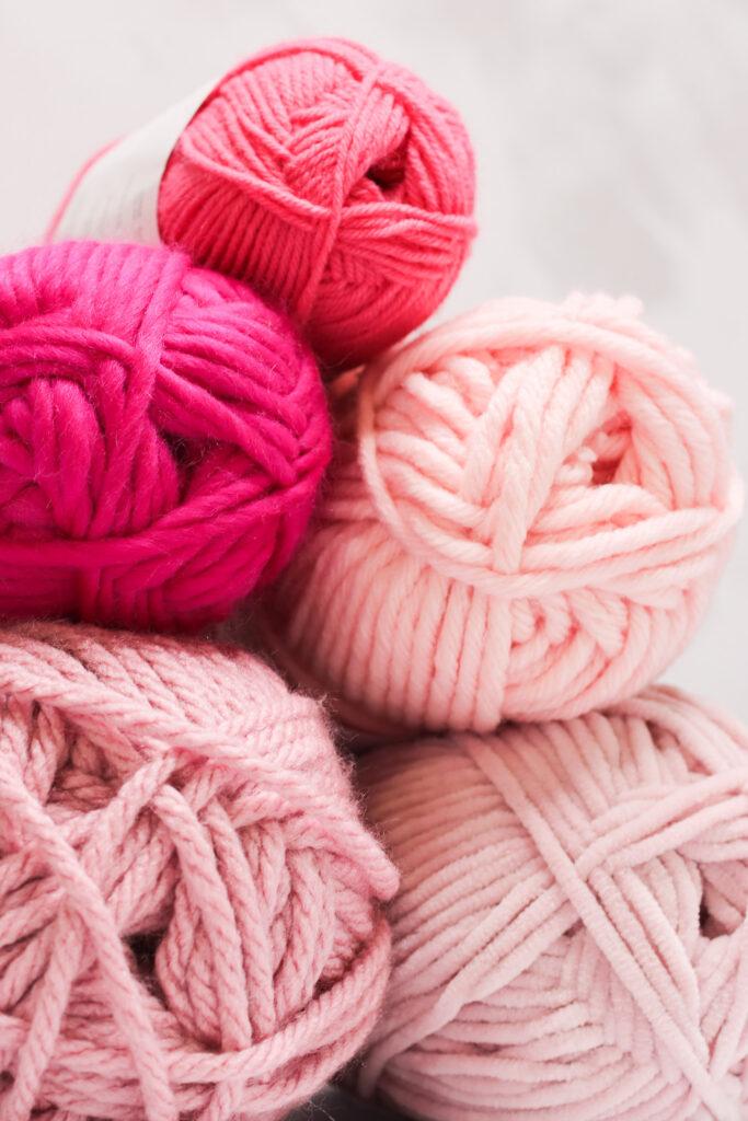 3 balls of pink yarn
