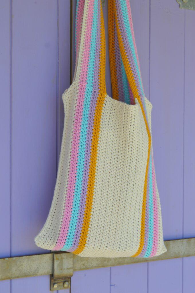 Crochet beach bag against wooden panelling