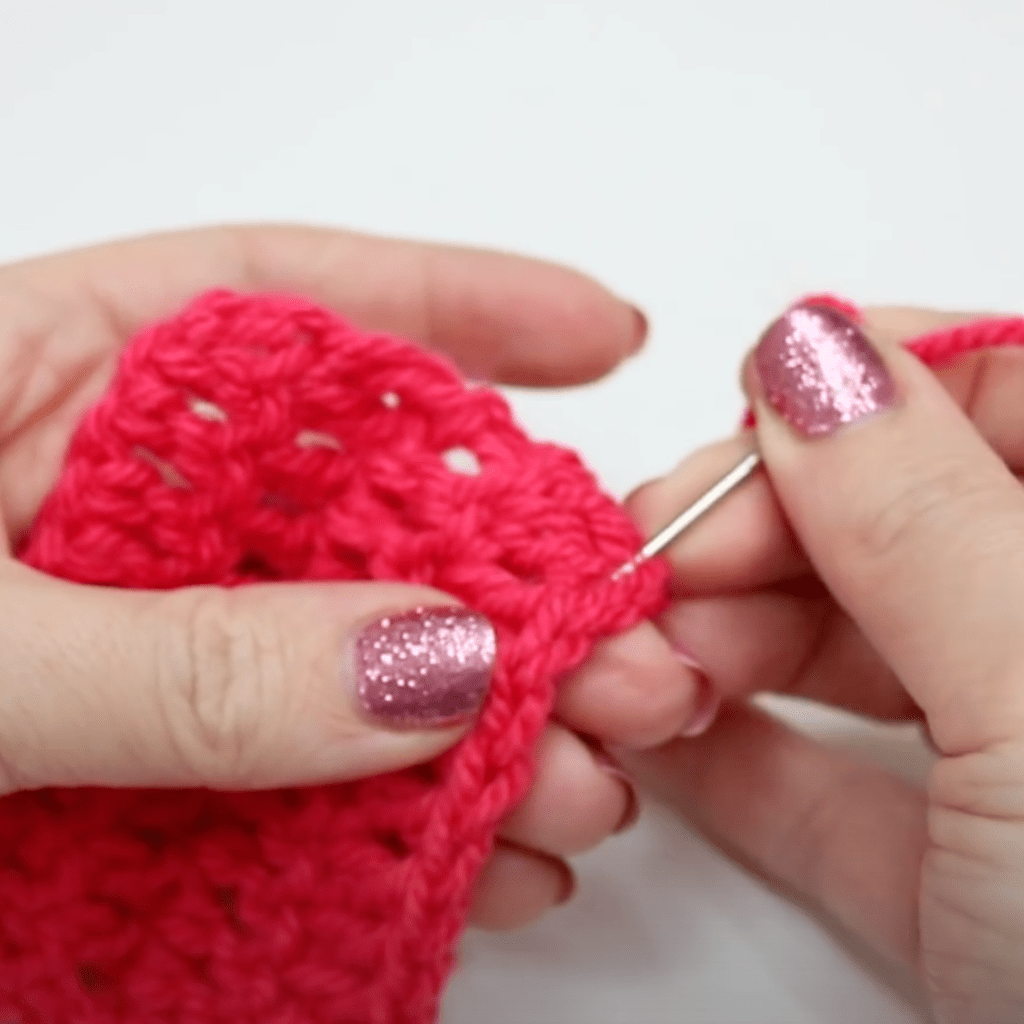 Sewing in the ends of a crochet project.