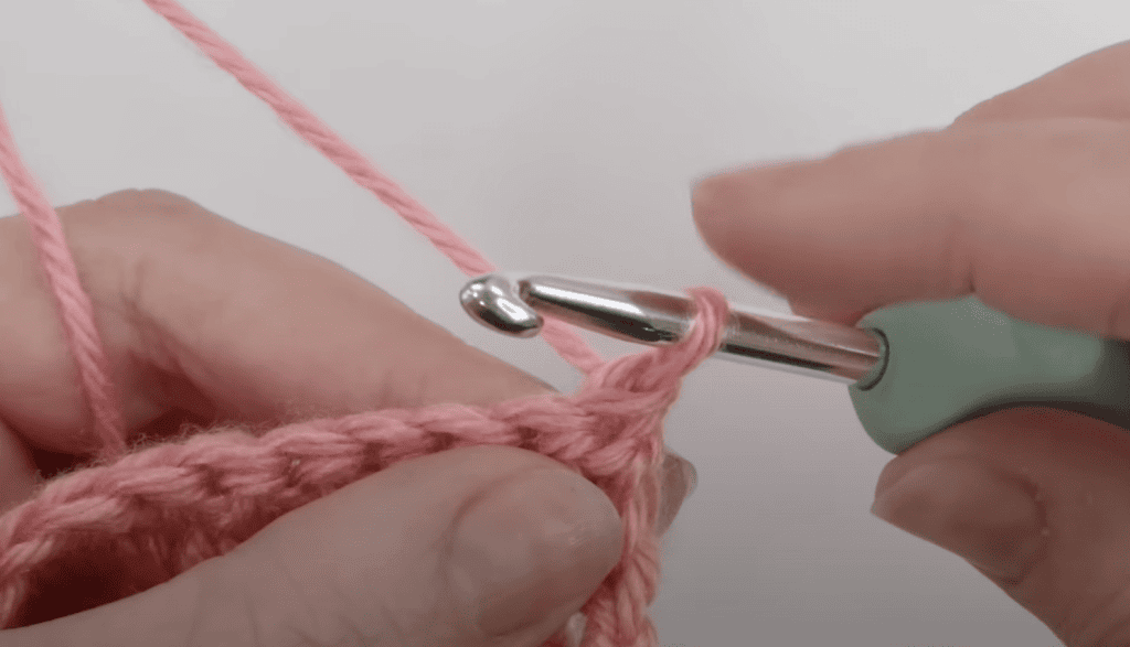 Starting double crochet stitch - lifting the loop to the height of the stitch.