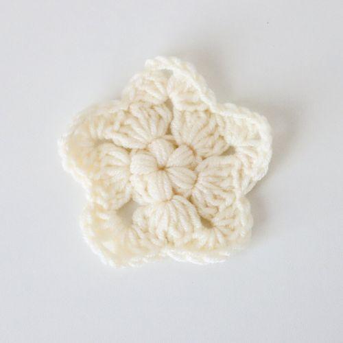 a flat lay image of a crochet star made in cream baby DK yarn to show how it looks using this yarn and a 4mm hook. 