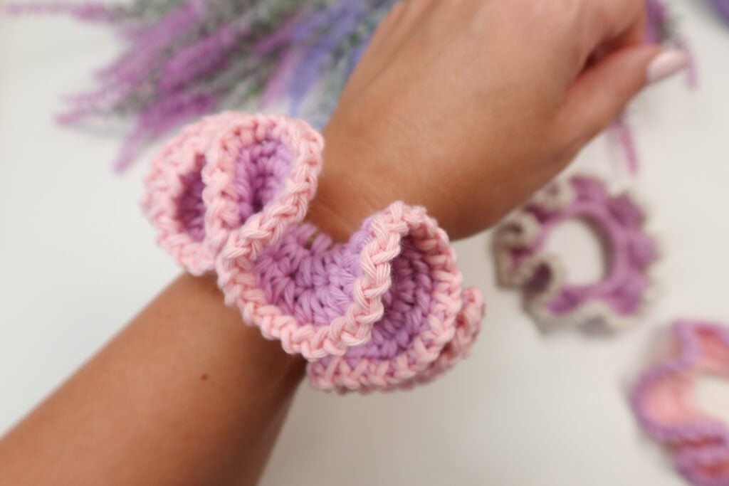 Crochet scrunchie on a woman's wrist. 