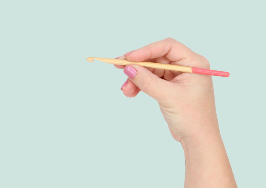 Holding a crochet hook using the pencil grip 